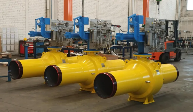 Yellow actuated valve assemblies lined up in the TMK workshop